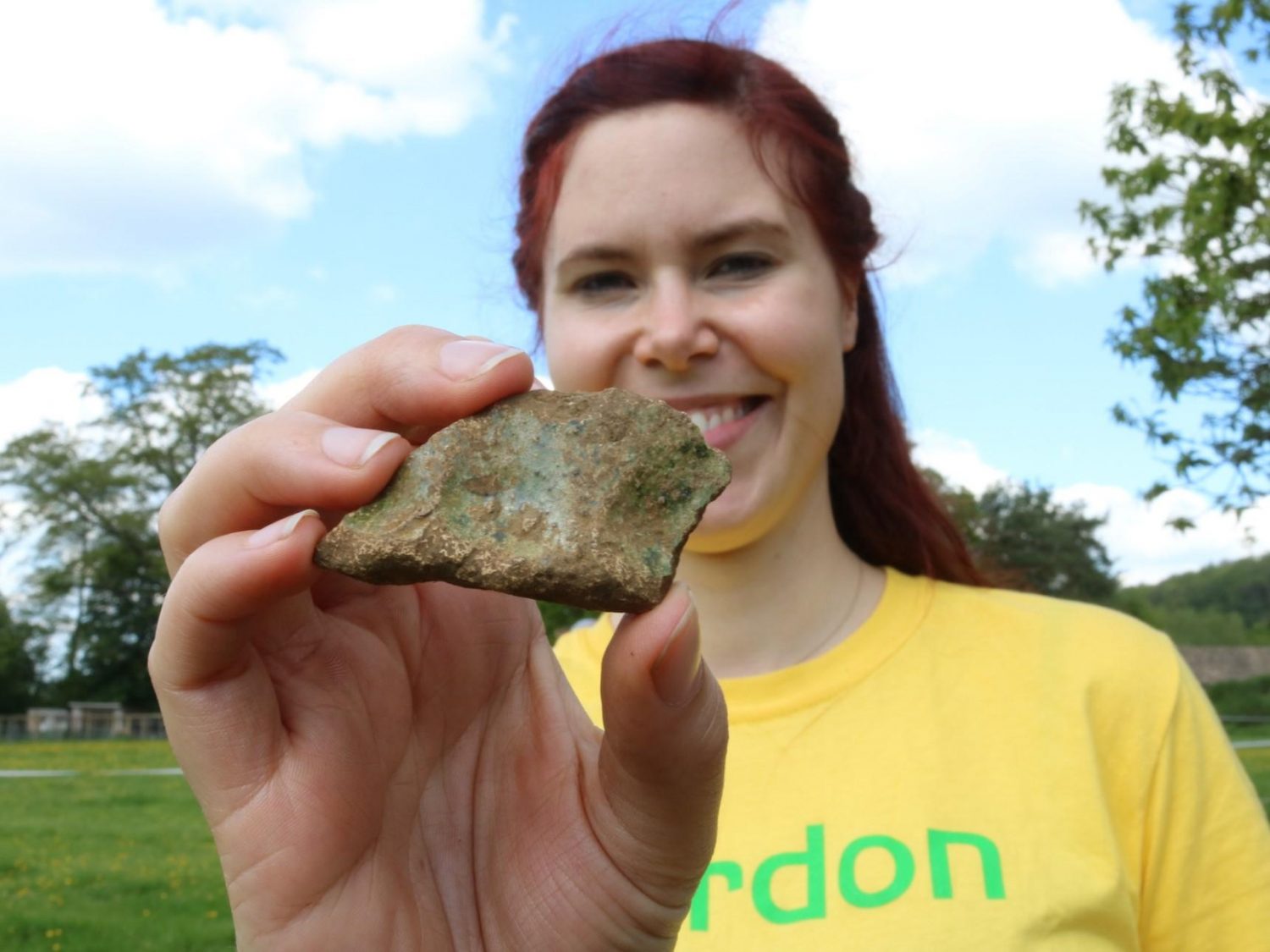 A woman holding a piece of Tudor pottery dug up from a trench in the Sudeley garden