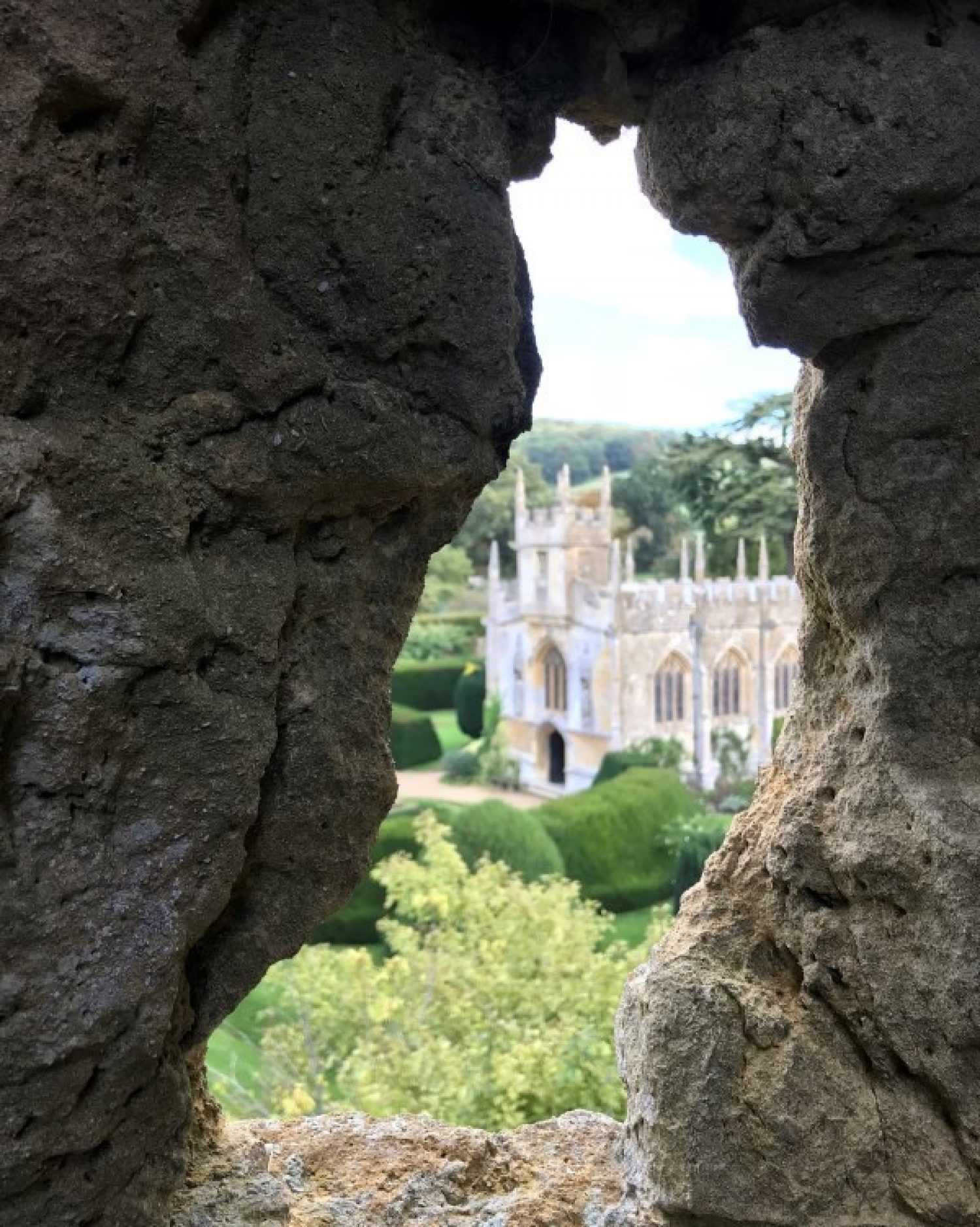 View of a church visible through a hole in a wall