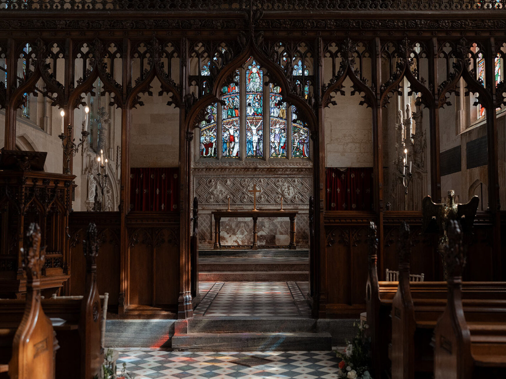 The inside of the chapel with natural sunshine illuminating the stained glass