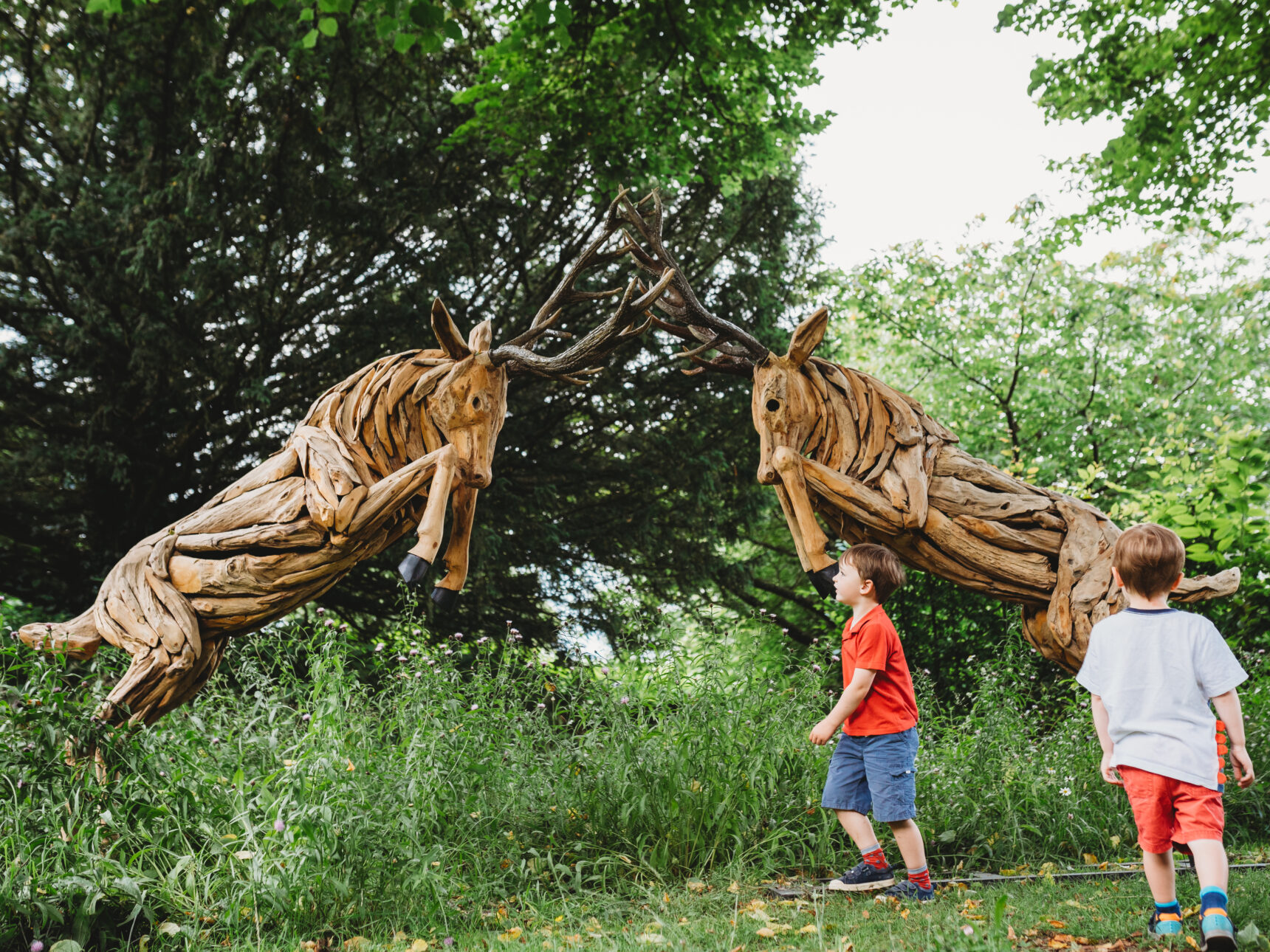Stag sculputes with children nearby
