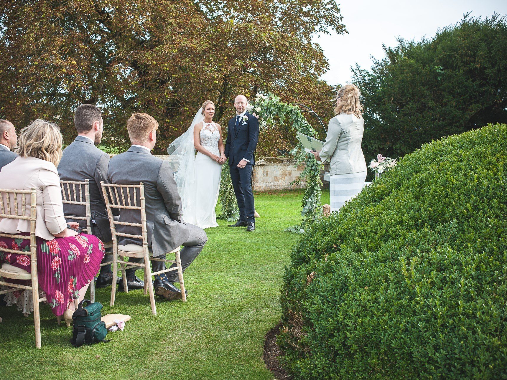 Bride and Groom saying vows on ha-ha behind Queen's Garden